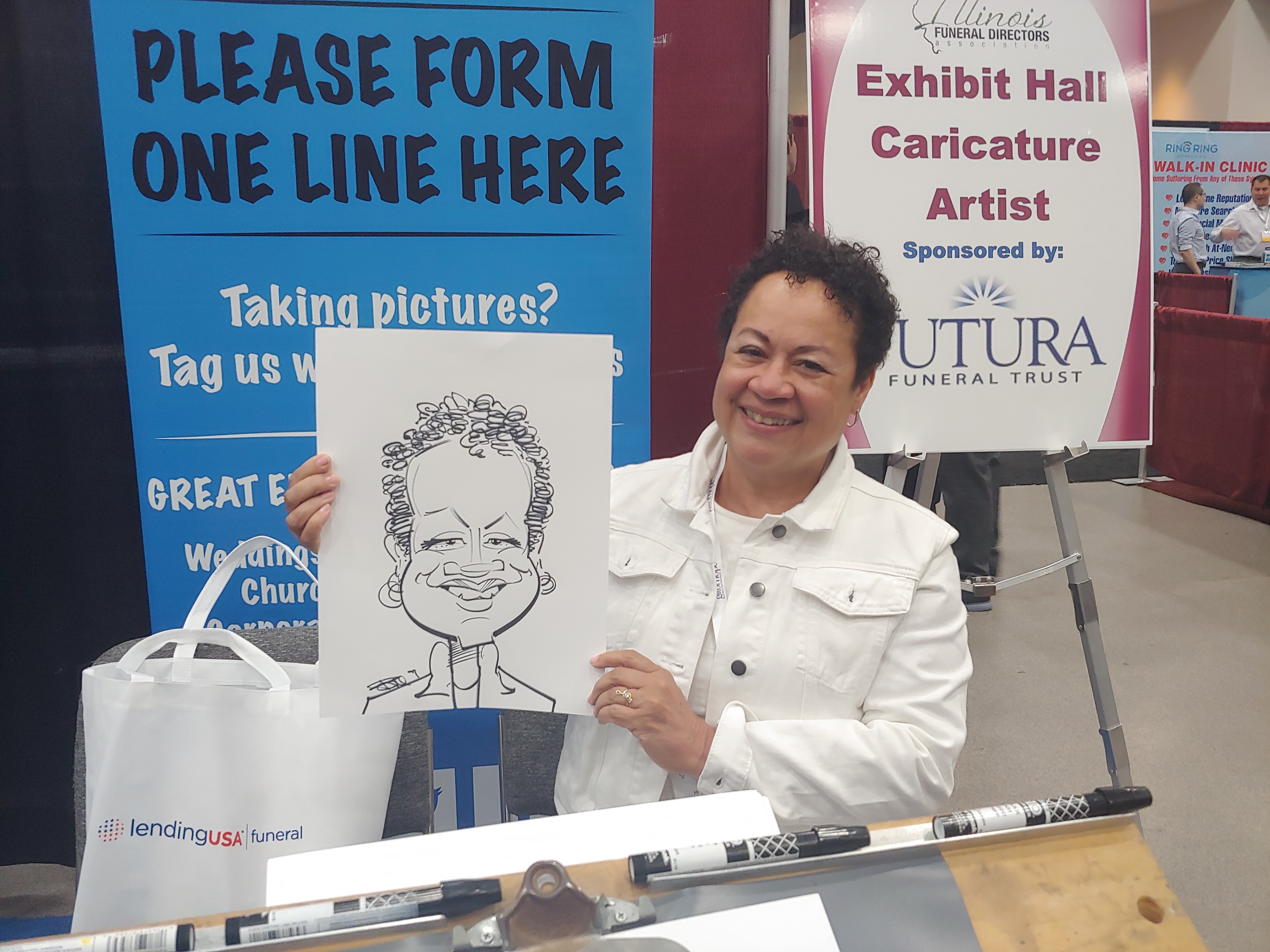 Woman holding caricature at Gateway Center Collinsville during the Illinois Funeral Directors Association Conference