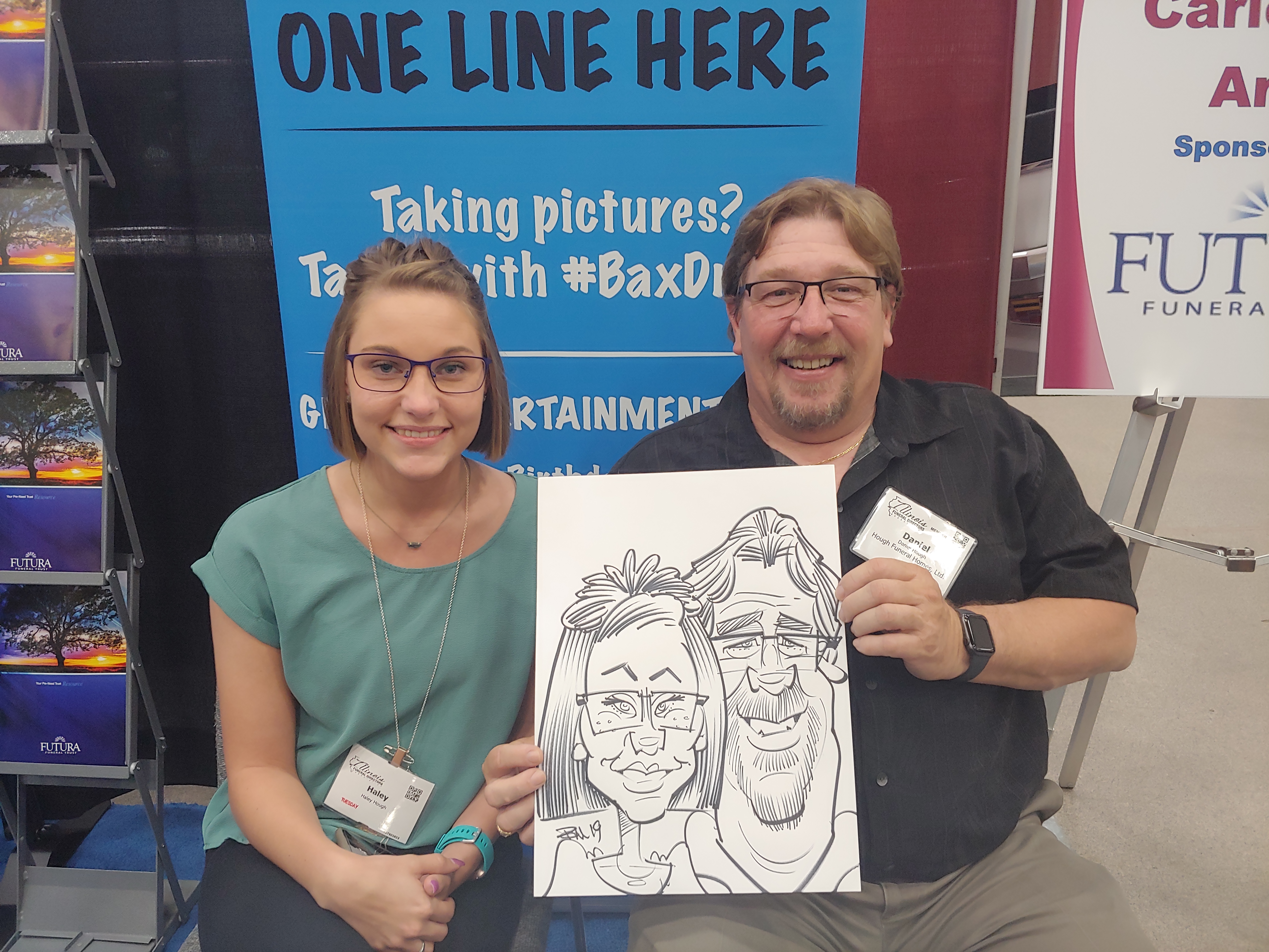 Father and Daughter holding caricature at Gateway Center Collinsville during the Illinois Funeral Directors Association Conference