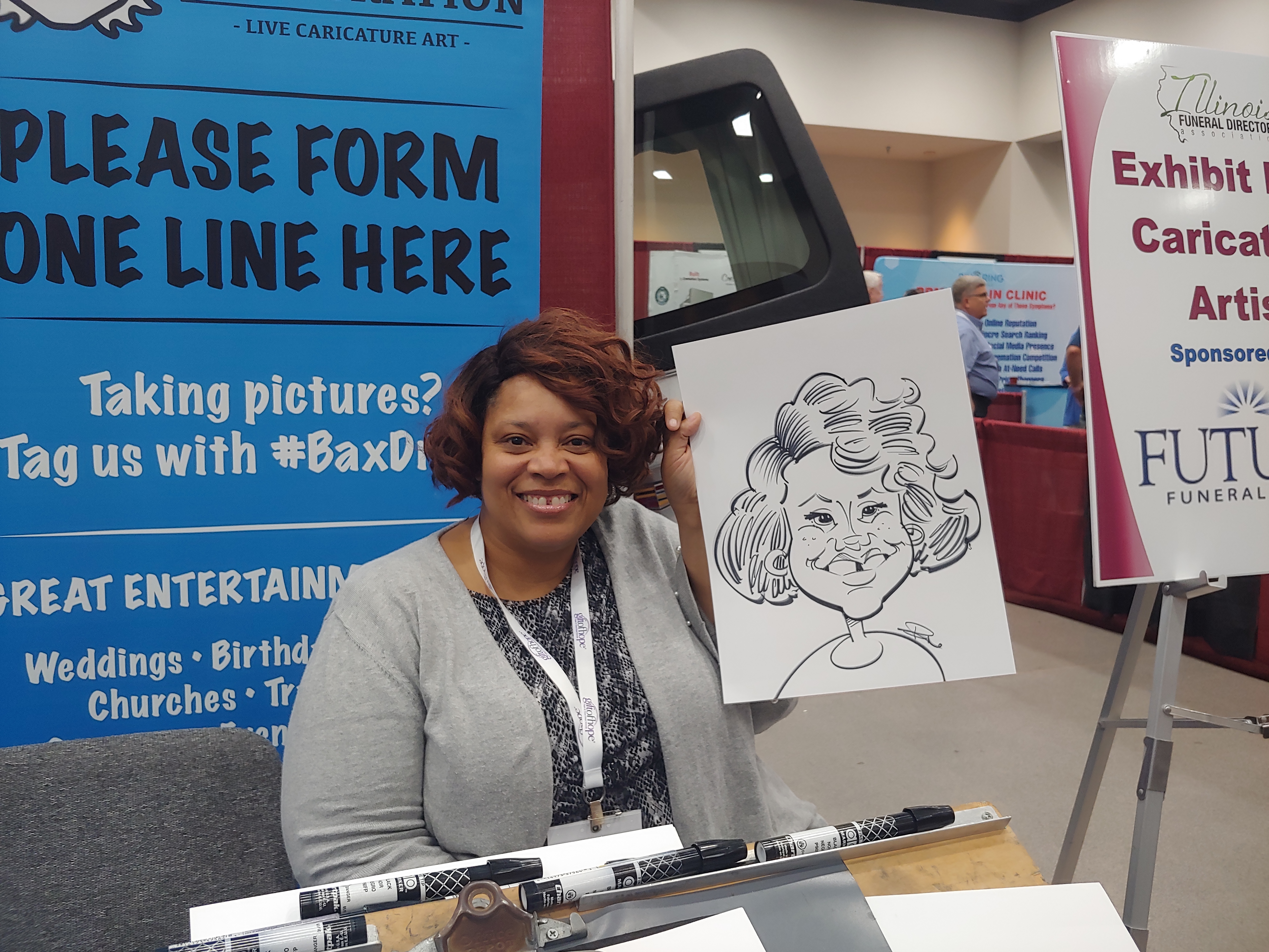 Woman holding caricature at Gateway Center Collinsville during the Illinois Funeral Directors Association Conference