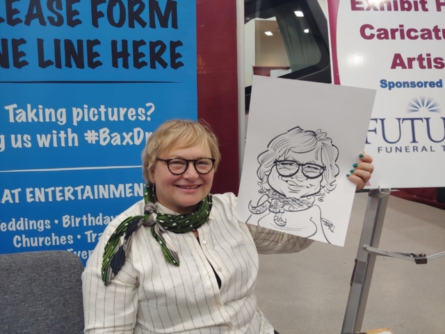 Woman holding caricature at Gateway Center Collinsville during the Illinois Funeral Directors Association Conference