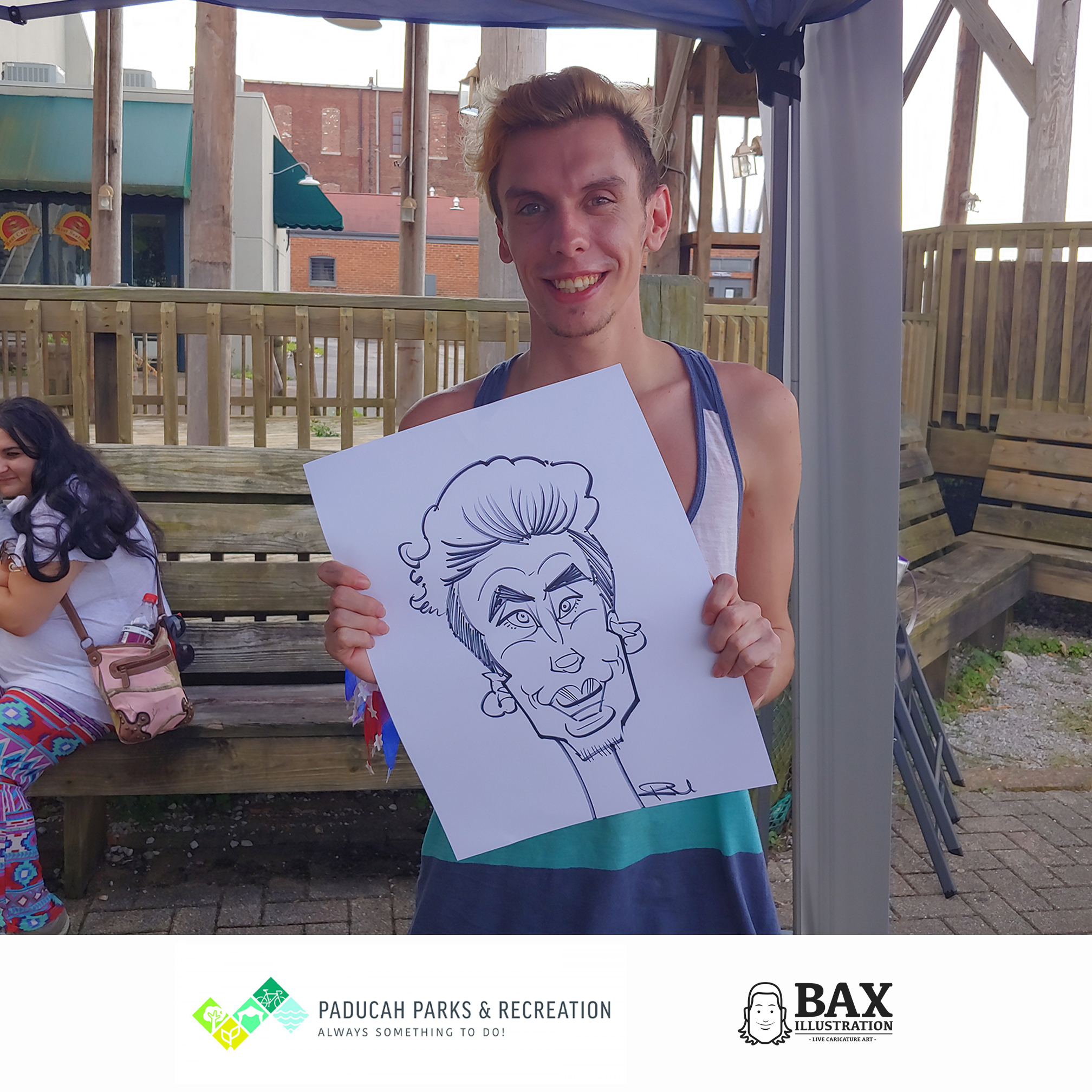 Guy holding caricature by Bax Illustration in Paducah Kentucky at the 2019 Independence Day Celebration