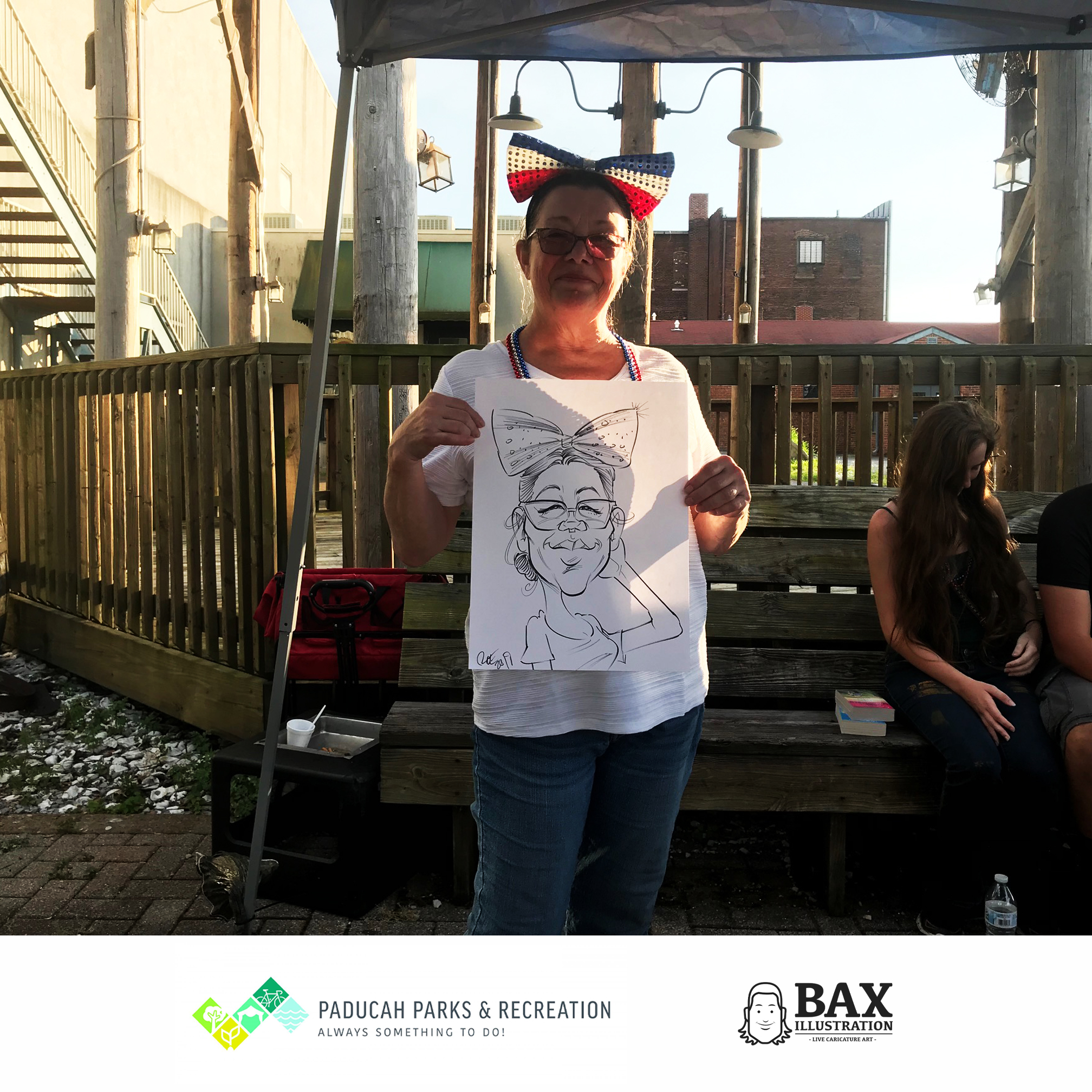 Woman holding caricature by Bax Illustration in Paducah Kentucky at the 2019 Independence Day Celebration