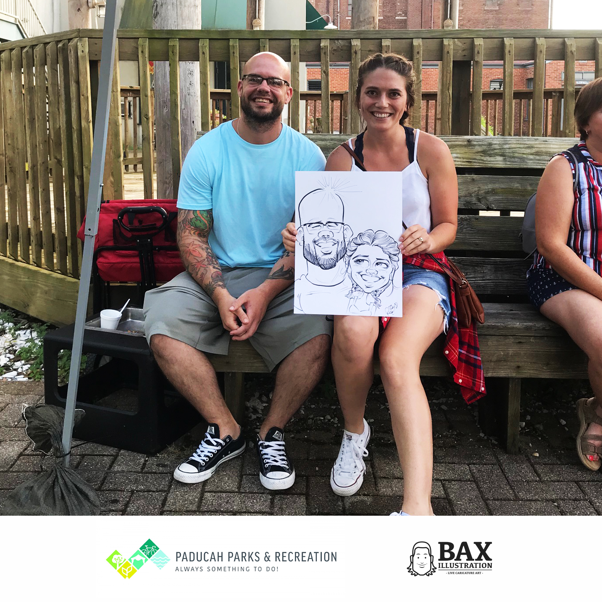 Couple holding caricature by Bax Illustration in Paducah Kentucky at the 2019 Independence Day Celebration